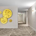 Resident corridor with art installation and new carpeting and lighting completed by capital