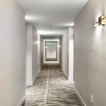 Resident corridor with updated lighting and carpets installed by Capital