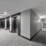 Penthouse elevator lobby and resident corridor with new flooring, lighting and wall coverings by Capital Contractor Services