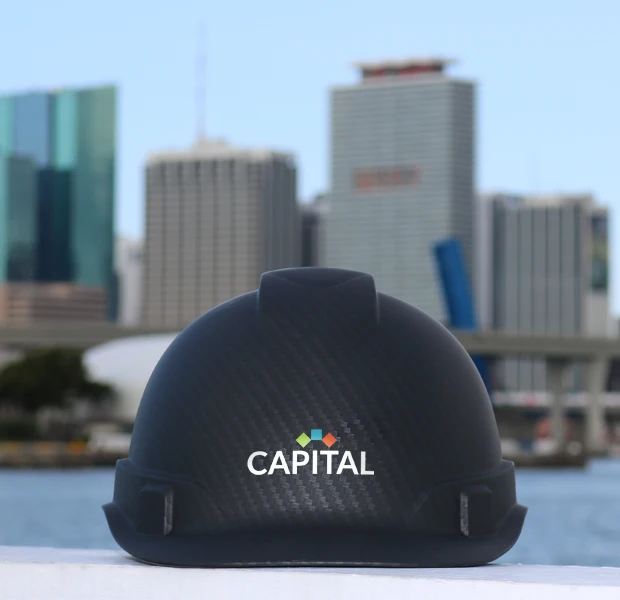 capital contractor services hard hat with maimi skyline in the background
